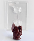 medium 3d turkey chocolate mold with a dark chocolate molded turkey in front of it. The turkey mold and finished turkey have texture and fine detail.