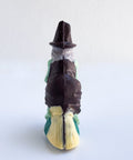 back side of 3d chocolate witch riding a broom stock.