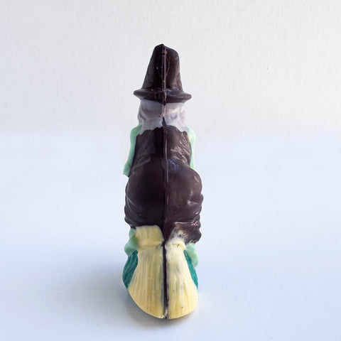 back side of 3d chocolate witch riding a broom stock.