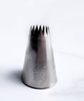 Metal 6B piping tip also known as Ateco 866 sitting on a white background.