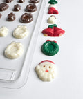 Decorative chocolate molds with shaped chocolates on a white background