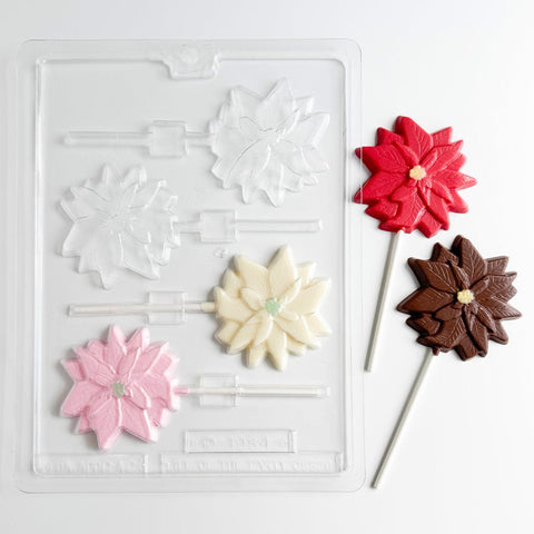Poinsettia pop candy mold with chocolate poinsettia lollipops next to it.