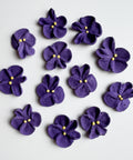 purple violets made from royal icing for decorating cakes and cupcakes