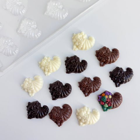 little chocolate cornucopias made with bite size cornucopia plastic candy mold shown in the top left hand corner.