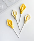 chocolate lollipops in the shape of calla lilys along side plastic mold