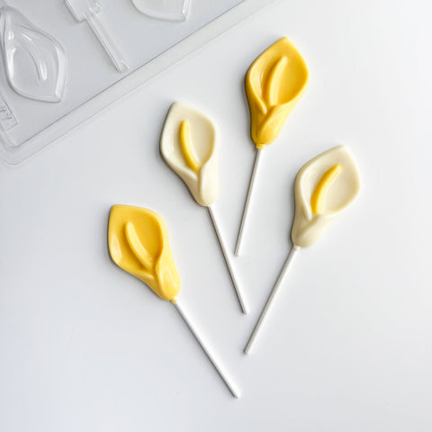 chocolate lollipops in the shape of calla lilys along side plastic mold