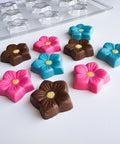 flower blossom chocolate mold along side flower shaped chocolate pieces