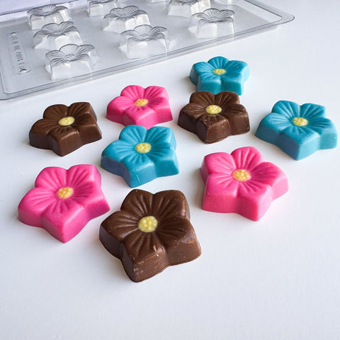 flower blossom chocolate mold along side flower shaped chocolate pieces