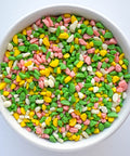 fruit punch flavored pink, yellow, white, and green candy crunch pieces for adding to chocolate or topping treats.