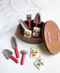 chocolate gardening set with little shovels, seed packets, and a basket made from chocolate and a mold