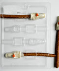 ghost pretzel rod chocolate mold with chocolate ghosts holding orange pumpkins