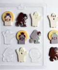 A Halloween-themed chocolate mold displayed on a white background, featuring various spooky shapes like ghosts, tombstones with 'RIP' text, a zombie, and a werewolf, shown both inside the clear plastic mold and as individual pieces.