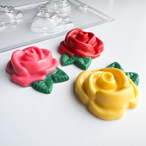 large rose chocolate pieces with plastic candy mold in the background