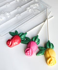 colorful rose shaped lollipops with plastic rose chocolate lollipop mold in the background