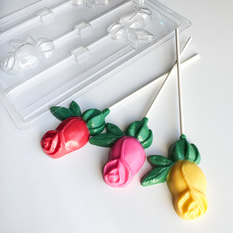 colorful rose shaped lollipops with plastic rose chocolate lollipop mold in the background