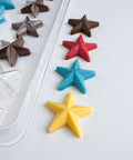 star shaped chocolate mold with chocolate stars next to it