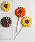 Homemade sunflower chocolate pops with milk chocolate centers and orange and yellow petals