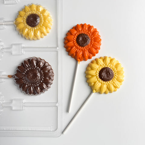 Homemade sunflower chocolate pops with milk chocolate centers and orange and yellow petals
