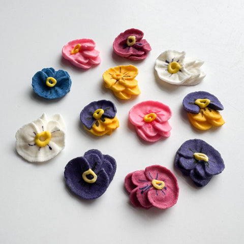 colorful royal icing sugar pansies used for decorating cakes and cupcakes