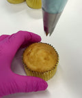 Showing how to use the 1M piping tip to pipe a swirl onto a cupcake