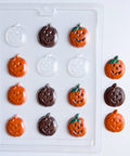 A clear plastic candy mold with 12 pumpkin-shaped cavities, shown alongside several decorated jack-o'-lantern chocolates in orange and dark brown with green stems on a white background.