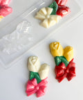 rose corsages made of chocolate with plastic candy mold in the background