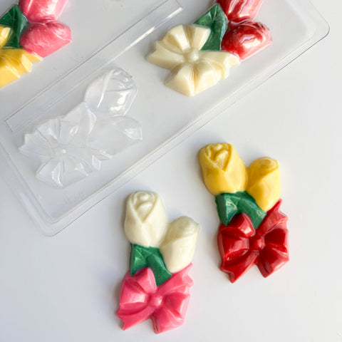 rose corsages made of chocolate with plastic candy mold in the background