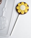 round lollipop with flower design with plastic mold in the background
