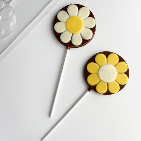 round flower lollipop with plastic chocolate mold in the background