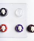 skull with swords sandwich cookie mold for molding oreo cookies. One finished molded oreo to the right made with dark chocolate for the base and white chocolate for the skull