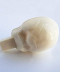 the back side of a white chocolate skull molded using a chocolate mold.