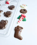 Small Christmas assortment candy mold makes an assortment of thin chocolate pieces in Christmas shapes.