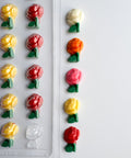 small rose chocolate pieces  with plastic candy mold in the background