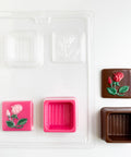 square chocolate box candy mold with rose imprinted on the cover 