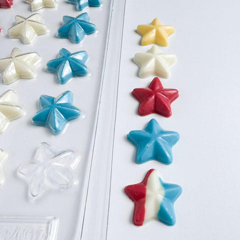 star shaped chocolate mold next to candy stars