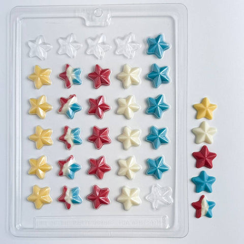 Star-shaped candy mold with chocolate stars next to plastic chocolate mold