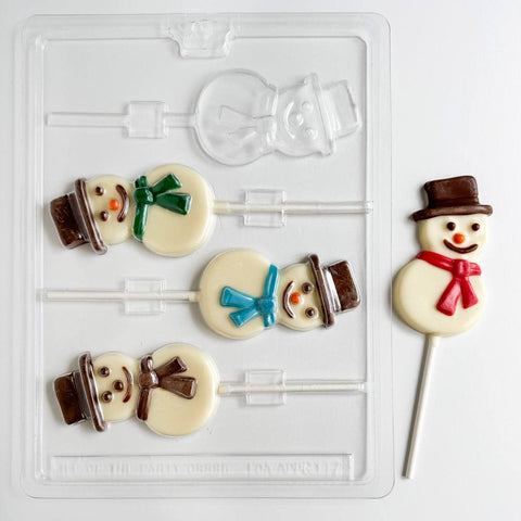 Smiling snowman pop candy mold along side snowman chocolate lollipops.