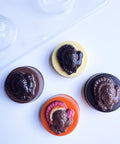 Four molded turkey oreos made with the sandwich cookie plastic candy mold shown in the top left corner.