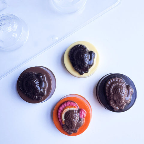 Four molded turkey oreos made with the sandwich cookie plastic candy mold shown in the top left corner.