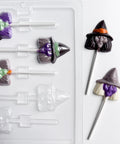 finished witch head lollipops shown along side the plastic chocolate mold used to make them