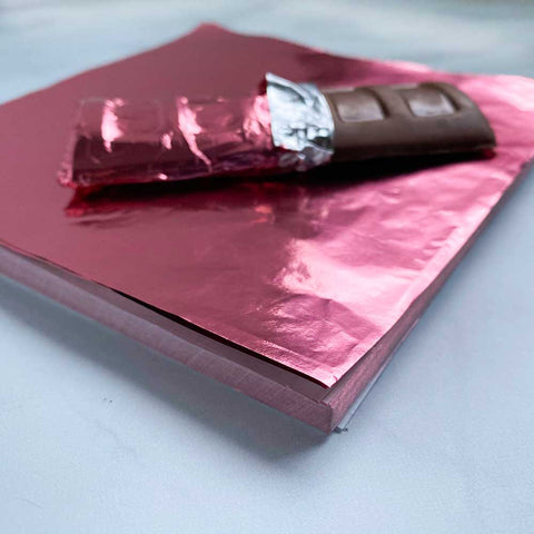 https://confectioneryhouse.com/cdn/shop/products/6x6-pink-candy-foil-wrappers_2.jpg?v=1684453344&width=480